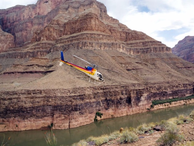 Fly in a helicopter over the Grand Canyon